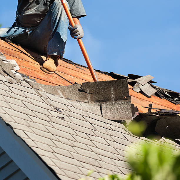 Roofers replacing old roof shingles with New shingles on residential home. removing shingles with roof jack